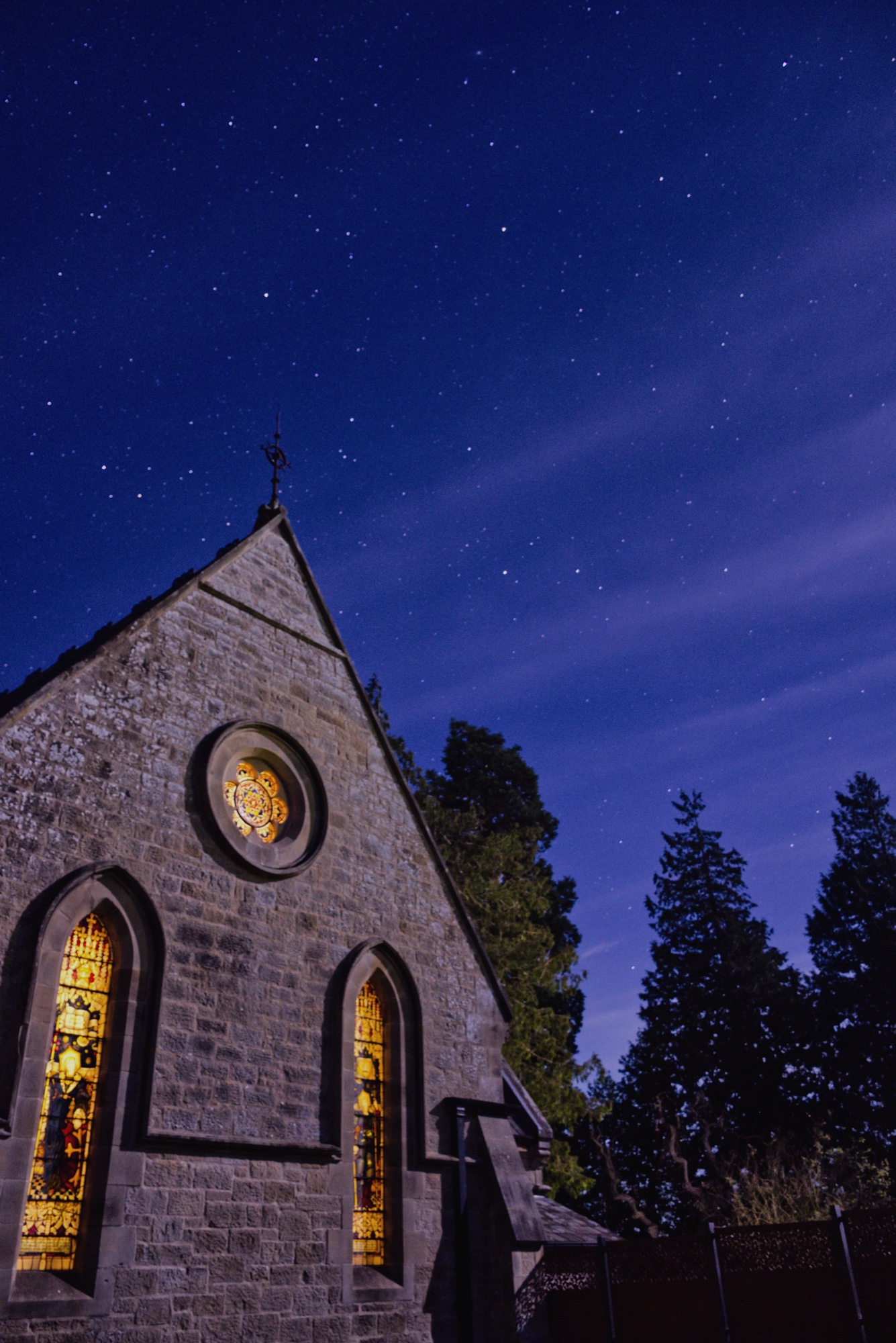 Stargazing above the illuminated stained glass windows at Warksburn Old Church